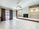 Open living room with fireplace, tiled floor, and sliding door to pool area at 1623 Carter Oaks Dr, Valrico, FL 33596