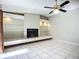View of living room including fireplace with display shelving and tile flooring at 1623 Carter Oaks Dr, Valrico, FL 33596