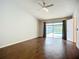 Main bedroom with wood floor, fan, and sliding glass doors leading to pool area at 1623 Carter Oaks Dr, Valrico, FL 33596