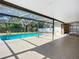 Backyard swimming pool with screened enclosure and concrete patio at 1623 Carter Oaks Dr, Valrico, FL 33596