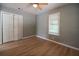 Serene bedroom with wood floors, a large window, and closet with bi-fold doors at 1716 11Th N Ave, St Petersburg, FL 33713