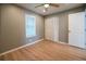 Comfortable bedroom with wood floors, large window, ceiling fan, and convenient closet at 1716 11Th N Ave, St Petersburg, FL 33713