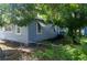 Charming home featuring blue siding, manicured lawn, fenced yard, and mature trees at 1716 11Th N Ave, St Petersburg, FL 33713