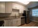 Bright kitchen featuring white cabinets, granite countertops, and modern stainless steel appliances at 1716 11Th N Ave, St Petersburg, FL 33713