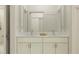 Elegant bathroom featuring double vanity with marble countertop and shower with subway tile surround at 18468 Serene Lake Loop, Lutz, FL 33548