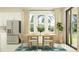 Bright dining area featuring a wooden table, stylish chairs, and natural lighting at 18468 Serene Lake Loop, Lutz, FL 33548