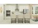 Bright kitchen featuring white cabinetry, stainless steel appliances, a center island, and breakfast bar at 18468 Serene Lake Loop, Lutz, FL 33548