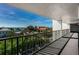 Wide angle shot of a balcony with black iron railing with a view of the ocean and tree tops at 19111 Vista Bay Dr # 603, Indian Shores, FL 33785