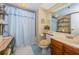Cozy bathroom with blue tile flooring and a shower with a blue decorative curtain at 19111 Vista Bay Dr # 603, Indian Shores, FL 33785