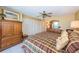 Comfortable bedroom with ample closet space, ceiling fan, and view to the outside at 19111 Vista Bay Dr # 603, Indian Shores, FL 33785