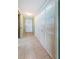 Bright hallway featuring tile flooring, storage closets, and a classic white door at 19111 Vista Bay Dr # 603, Indian Shores, FL 33785