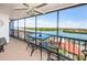 Relaxing lanai with water views, ceiling fan, and seating is perfect for enjoying coastal breezes and sunshine at 19111 Vista Bay Dr # 603, Indian Shores, FL 33785