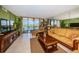 Comfortable living room with tile floors, a water view, and ample seating at 19111 Vista Bay Dr # 603, Indian Shores, FL 33785