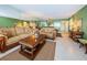 Inviting living room features comfortable seating, tile floors, and view into dining space at 19111 Vista Bay Dr # 603, Indian Shores, FL 33785