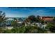 Breathtaking ocean view from a high vantage point showcasing lush trees and quaint residential homes at 19111 Vista Bay Dr # 603, Indian Shores, FL 33785