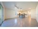 Spacious living area featuring tiled flooring, sliding glass doors, ceiling fan, and an open concept to the kitchen at 1926 Pleasant Maple Ct, Bradenton, FL 34211