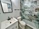 Bathroom features a modern vanity, toilet, and tiled walk-in shower at 2020 World Parkway Blvd # 14, Clearwater, FL 33763