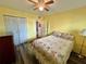Bedroom featuring yellow walls, hardwood floors, ceiling fan and closet at 2020 World Parkway Blvd # 14, Clearwater, FL 33763