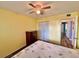 Bedroom featuring yellow walls, hardwood floors, ceiling fan and closet at 2020 World Parkway Blvd # 14, Clearwater, FL 33763
