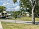 Street view of the exterior featuring mature trees and beautiful surrounding landscape at 2020 World Parkway Blvd # 14, Clearwater, FL 33763