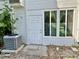 Exterior view of the home featuring a door, windows, and an air conditioning unit at 2020 World Parkway Blvd # 14, Clearwater, FL 33763
