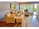 Open concept living room features plush seating and an adjacent entry door at 2020 World Parkway Blvd # 14, Clearwater, FL 33763