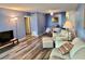 Open concept living room area with vinyl plank floors and bright blue walls at 2020 World Parkway Blvd # 14, Clearwater, FL 33763