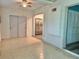 Open living space with tile flooring that leads to the kitchen area at 2020 World Parkway Blvd # 14, Clearwater, FL 33763