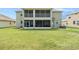 Spacious backyard featuring a two-story home with screened-in porch and balcony, perfect for outdoor relaxation at 20251 Ravens End Dr, Tampa, FL 33647