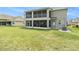 Expansive backyard with a two-story home featuring screened-in porch and balcony for outdoor enjoyment at 20251 Ravens End Dr, Tampa, FL 33647