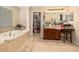 Bright bathroom with a tub, walk-in closet, and large vanity at 20251 Ravens End Dr, Tampa, FL 33647