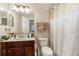 Bathroom featuring a single sink vanity and shower with patterned curtain at 20251 Ravens End Dr, Tampa, FL 33647