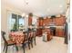 Bright eat-in kitchen boasts wood cabinets, an island, and sliding door to the lanai at 20251 Ravens End Dr, Tampa, FL 33647