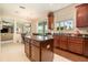 Bright eat-in kitchen with dark wood cabinets, island, and sliding glass doors at 20251 Ravens End Dr, Tampa, FL 33647