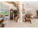 Spacious tiled foyer with elegant staircase leading upstairs and views into the living and dining rooms at 20251 Ravens End Dr, Tampa, FL 33647