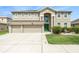 Charming two-story home with a three car garage, well manicured lawn, and freshly painted exterior at 20251 Ravens End Dr, Tampa, FL 33647