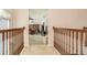 Upstairs hallway features wood railing and an overlook into a living space at 20251 Ravens End Dr, Tampa, FL 33647