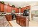 Well-equipped kitchen with granite counters, island, and dark wood cabinetry at 20251 Ravens End Dr, Tampa, FL 33647