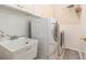 Functional laundry room equipped with washer, dryer, utility sink and tile floor at 20251 Ravens End Dr, Tampa, FL 33647