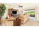 Bright living room featuring a ceiling fan, neutral carpet and serene views of the backyard pond at 20251 Ravens End Dr, Tampa, FL 33647