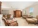 Inviting formal living room featuring neutral carpet, lots of natural light, and view into the dining room at 20251 Ravens End Dr, Tampa, FL 33647