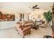Spacious living room with neutral carpet, ceiling fan and an open view into the modern kitchen at 20251 Ravens End Dr, Tampa, FL 33647