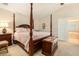 Primary bedroom includes a four poster bed, an ensuite bathroom, and a chest at 20251 Ravens End Dr, Tampa, FL 33647