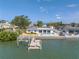 Backyard view of the home with a waterfront view, pool and private dock at 2140 Dolphin S Blvd, St Petersburg, FL 33707