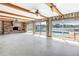 Open living room with exposed brick, wood beams and sliding glass doors with a view of the pool at 2140 Dolphin S Blvd, St Petersburg, FL 33707