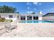Backyard pool features a brick patio, sliding glass doors and an outdoor dining set at 2140 Dolphin S Blvd, St Petersburg, FL 33707