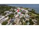Aerial view of condo building nestled within a tree-lined neighborhood with a glimpse of Tampa Bay at 231 2Nd S St # 201, Safety Harbor, FL 34695