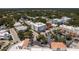 Aerial view of a four-story condo building with street parking within a quaint neighborhood at 231 2Nd S St # 201, Safety Harbor, FL 34695