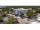 Aerial view of condo building surrounded by lush greenery, street parking, and charming neighborhood details at 231 2Nd S St # 201, Safety Harbor, FL 34695