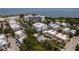 Aerial view of a condo building near the water, displaying a charming community with ample parking and lush greenery at 231 2Nd S St # 201, Safety Harbor, FL 34695